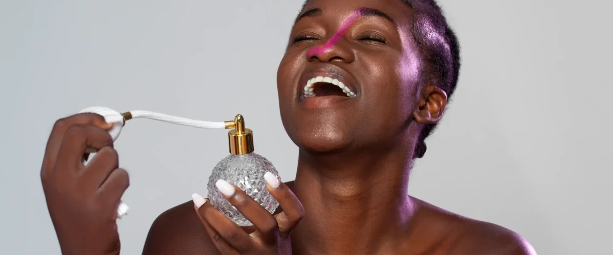 front view woman holding perfume (1)